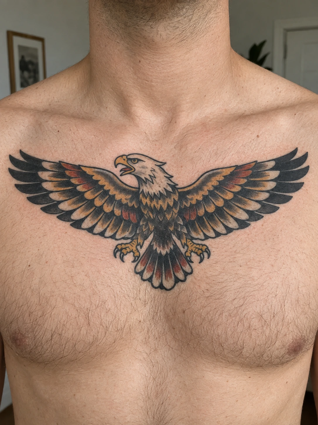Spread wings follow the horizontal space across the upper chest.